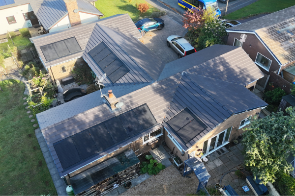 A bungalow with solar panels on four sides of its pitched roof